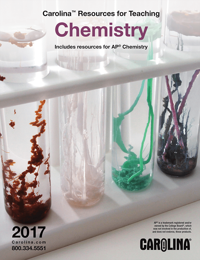 Four test tubes with different colors of things growing in them